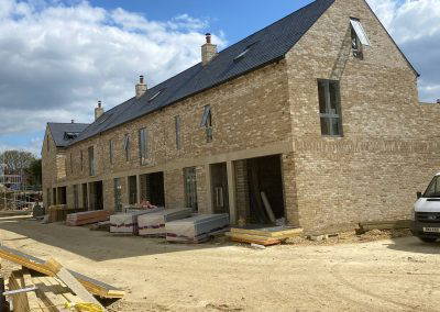 A row of modern brick townhouses under construction
