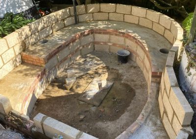 G.C Bricklaying & Building Services LTD: Custom curved stone and brick pond construction.